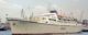 The cruise ship Oceanos leaving Piraeus Harbor on June 1986. Photo by Peter J. Fitzpatrick, CC BY-SA 4.0, via Wikicommons https://commons.wikimedia.org/w/index.php?curid=41123433 https://en.wikipedia.org/wiki/MTS_Oceanos#/media/File:"Oceanos"_-_Piraeus,_1986.jpg