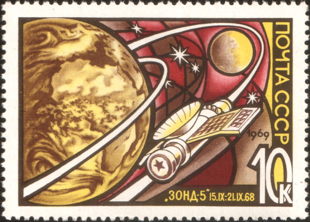 A 1969 USSR stamp of Zond 5, showing the spacecraft orbiting the moon. Image via Wikicommons https://en.wikipedia.org/wiki/Zond_5#/media/File:The_Soviet_Union_1969_CPA_3733_stamp_(Zond_5).png