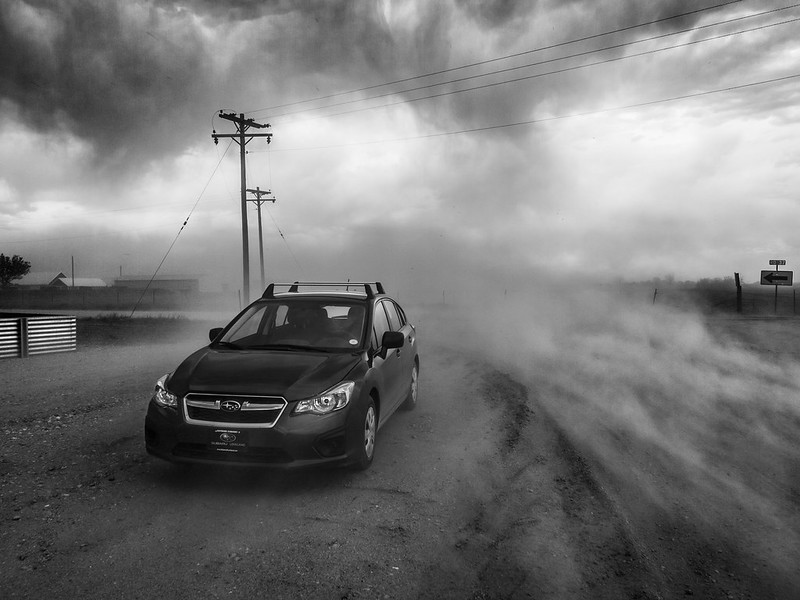 A car driving through a microburst, which looks like a cross between a tornado and heavy fog. (Photo by Bryce Bradford via Flickr/Creative Commons https://flic.kr/p/bBUnmo)