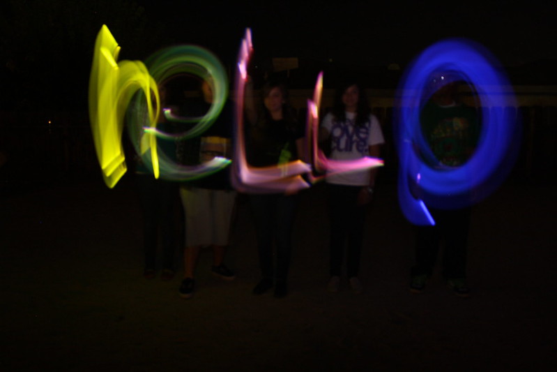 A long-exposure photo shows five people using lights to "paint" the word "hello" into the air. (Photo by ashley norquist via Flickr/Creative Commons https://flic.kr/p/79Sns6)