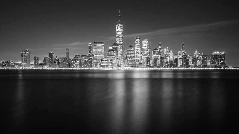 A black and white photo of Lower Manhattan's skyline at night. (Photo by Peter Miller via Flickr/Creative Commons https://flic.kr/p/2n1Ccue)