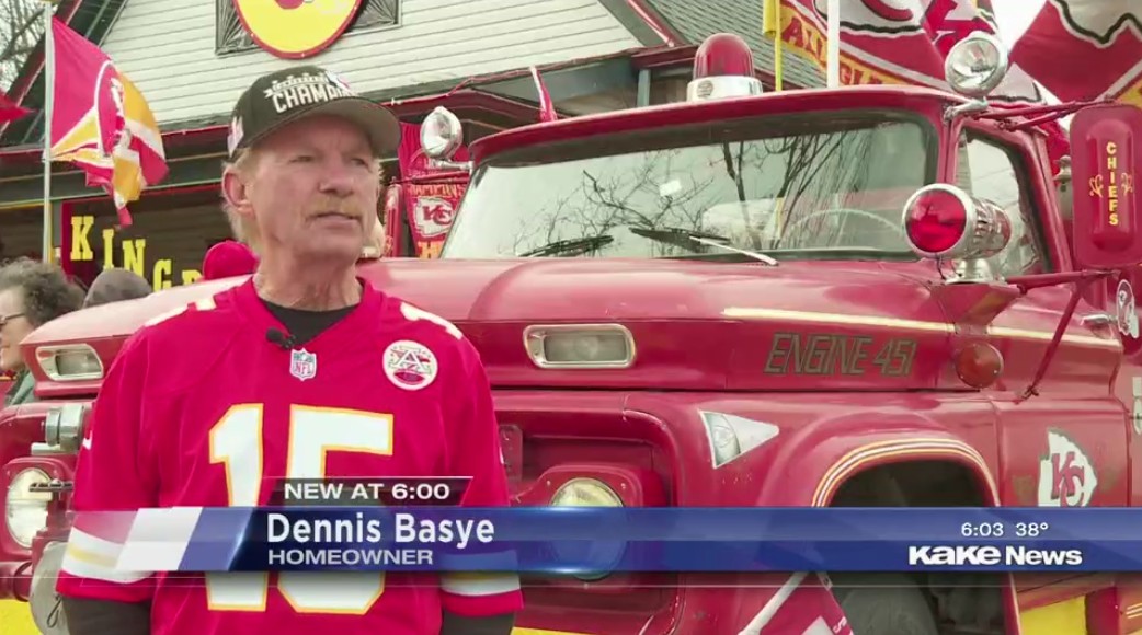 Dennis Basye: Homeowner. In the background, everything is Kansas City red and white, including a fire engine, the house and the yard.
