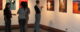 People look at paintings at an art gallery. (Photo by Wade Rockett via Flickr/Creative Commons https://flic.kr/p/rzTs8)