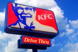 A KFC sign features the smiling face of Colonel Sanders. (Photo by Mike Mozart via Flickr/Creative Commons https://flic.kr/p/ok68tL)