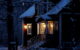 A house with its exterior lights on, during a slightly snowy and dark evening. (Photo by Mumes World via Flickr/Creative Commons https://flic.kr/p/BohBXy)