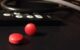 Two red acetaminophen pills on a black surface. (Photo by Nathanael Hevelone via Flickr/Creative Commons https://flic.kr/p/bwd2UR)