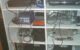 A shelf holds multiple video game consoles, controllers and cables (this is not the setup featured in today's show). Photo by x212 via Flickr/Creative Commons https://flic.kr/p/3zGX6