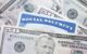 A Social Security card partially covered by US paper money. (Photo by Alpha Photo via Flickr/Creative Commons https://flic.kr/p/2ockYJc)