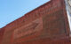 A faded ad on the side of a brick building advertises Wrigley's Spearmint Gum. Photo by realitymorsel via Flickr/Creative Commons https://flic.kr/p/bsAzcD