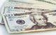 Several twenty dollar bills fanned out on a flat white surface. Photo by ajay_suresh via Flickr/Creative Commons https://flic.kr/p/2mXDbku