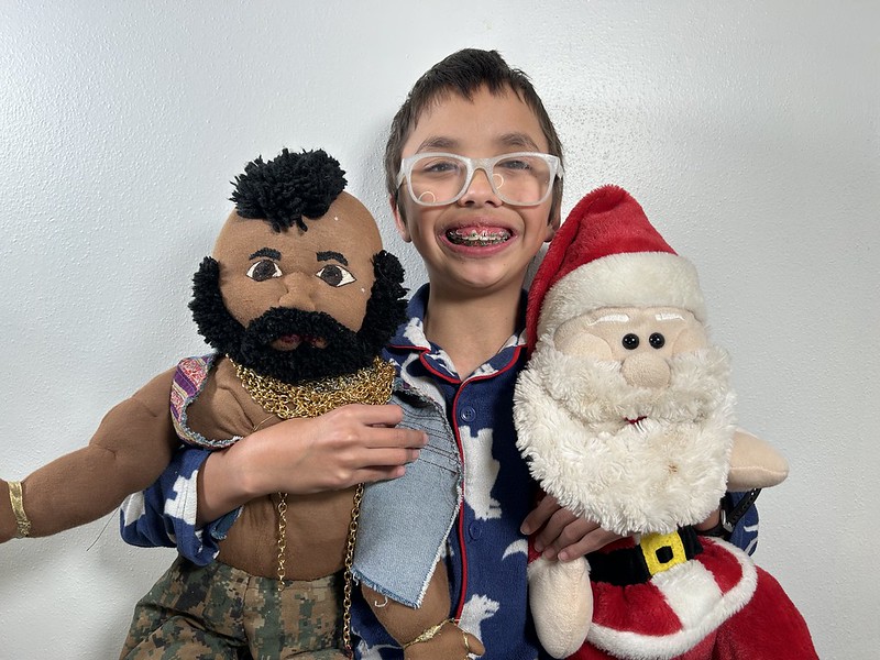 The almost eleven year old poses with Santa and Mr. T